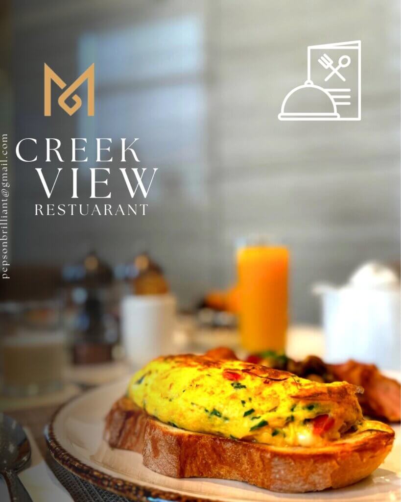Delicious breakfast omelet served on toasted bread with fresh herbs, set on a restaurant table with orange juice and tableware, promoting Creek View Restaurant